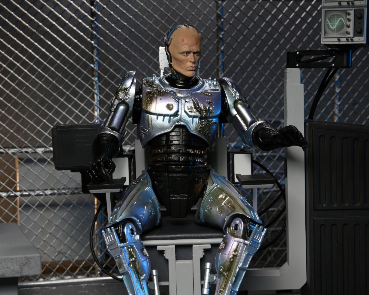 RoboCop – Official Ultimate Battle-Damaged RoboCop with Chair Figure Action Figure - Tophatter Daily Deals