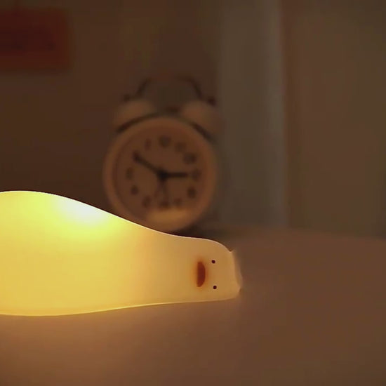 "Dreamy Nights with "Benson The Lazy Buddy": Adorable Lying Flat Duck Night Light" - Tophatter  Introducing our favorite cutie the charming duck night light that transforms bedtime into a magical experience. More than just a night light, Benson is a whimsical companion, radiating a warm and comforting glow to lull you into a serene night's sleep. Elevate your nights with this delightful addition to your space.